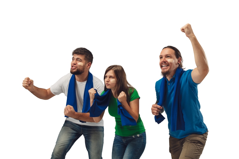 Excellent goal. Three soccer fans woman and men cheering for favourite sport team with bright emotions isolated on white studio background. Looking excited, supporting. Concept of sport, fun, support.